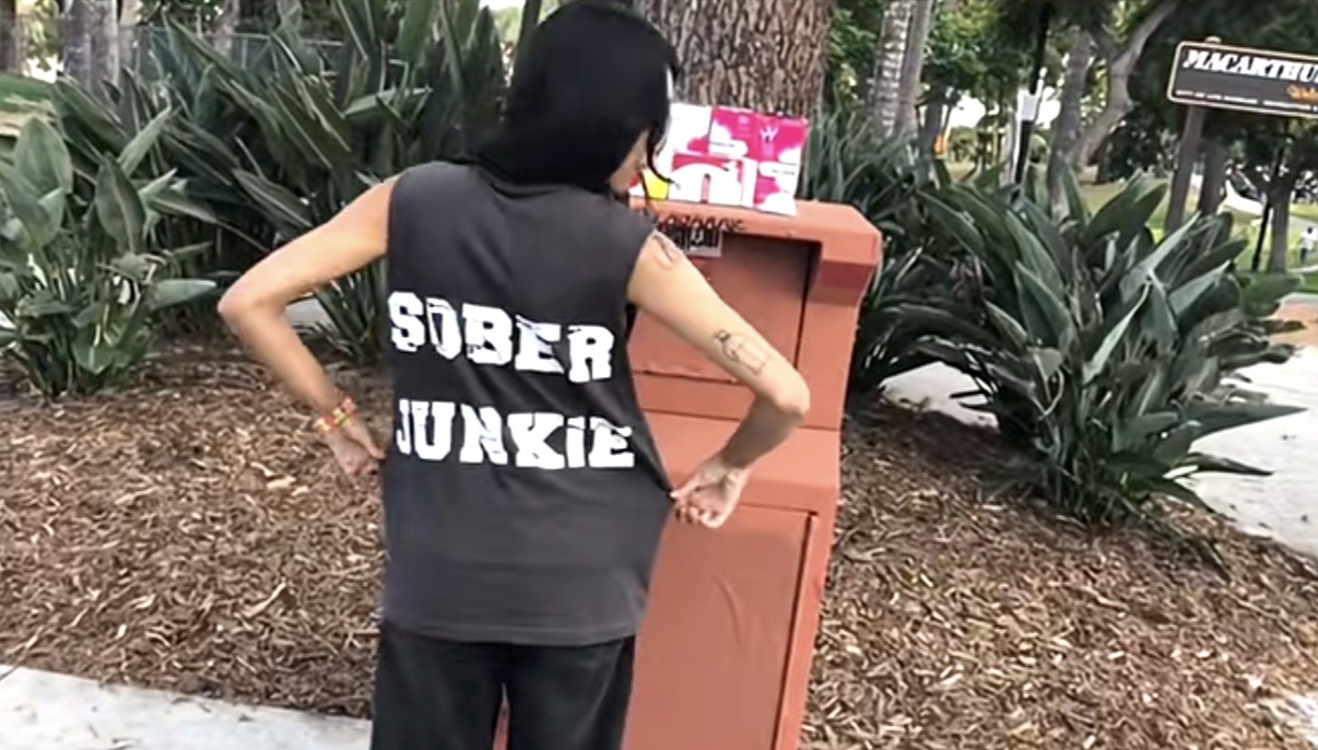 Back of the SOBER JUNKIE shirt while Crystal stocks free Narcan